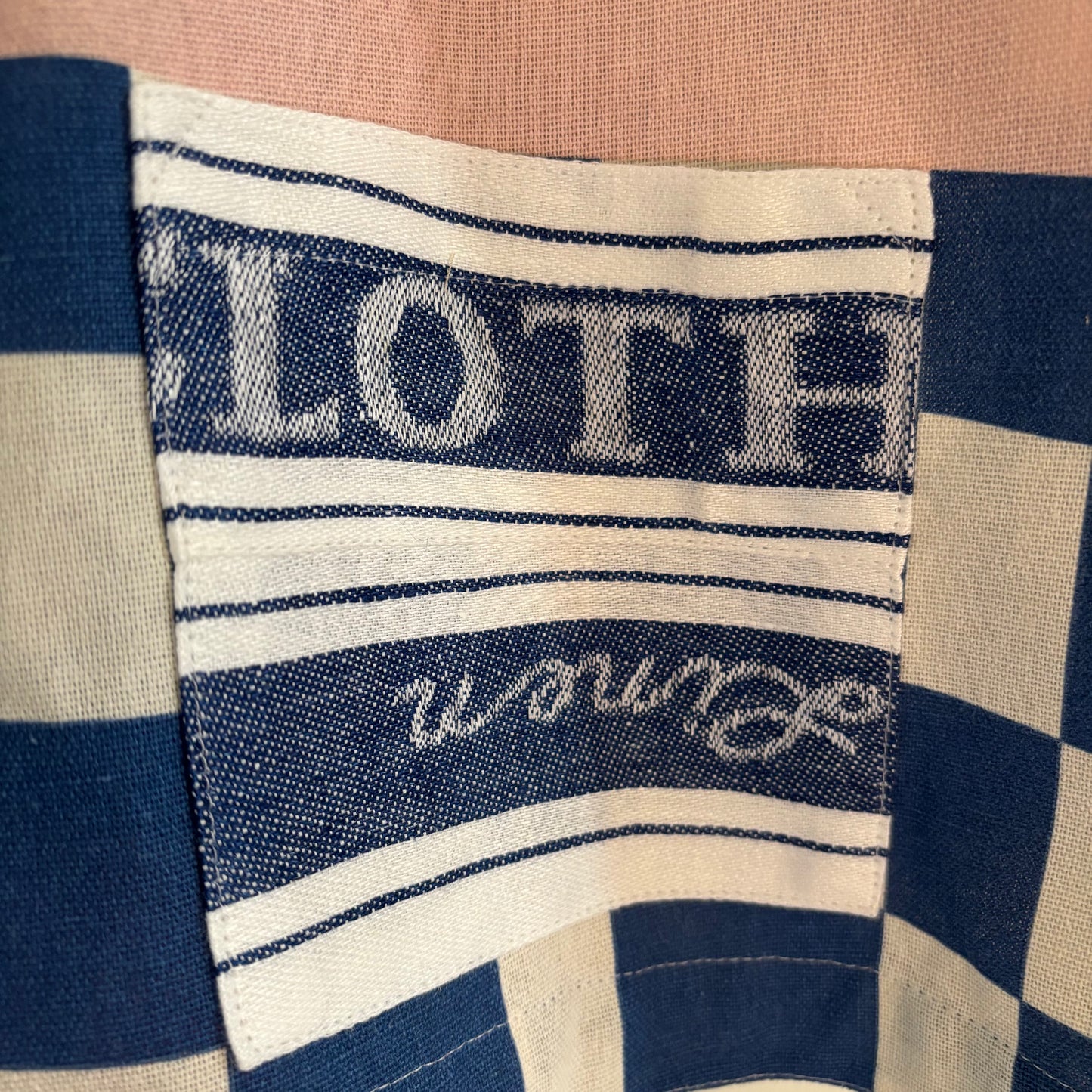 Longer length tea-shirt with pattern and travel destinations.