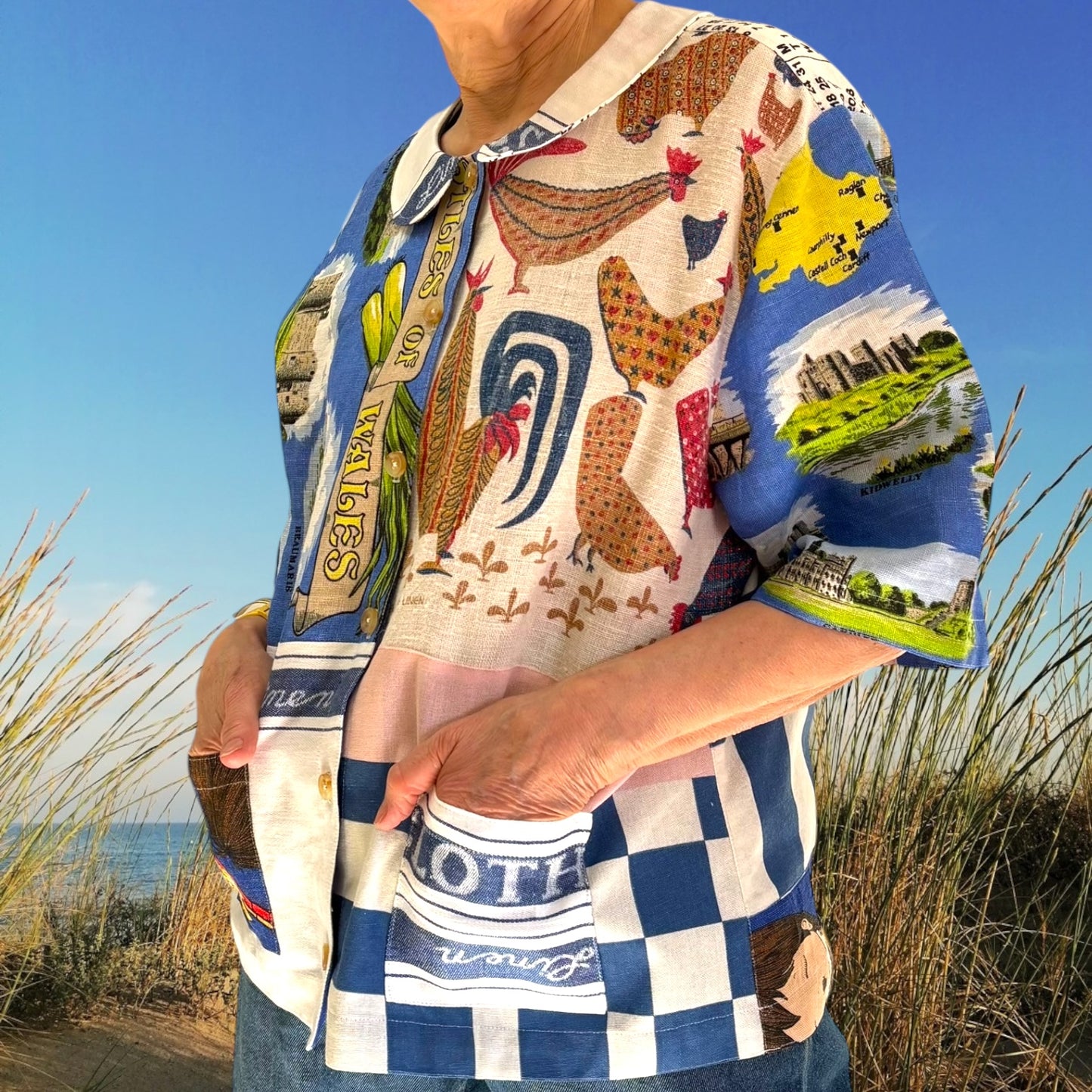 Longer length tea-shirt with pattern and travel destinations.