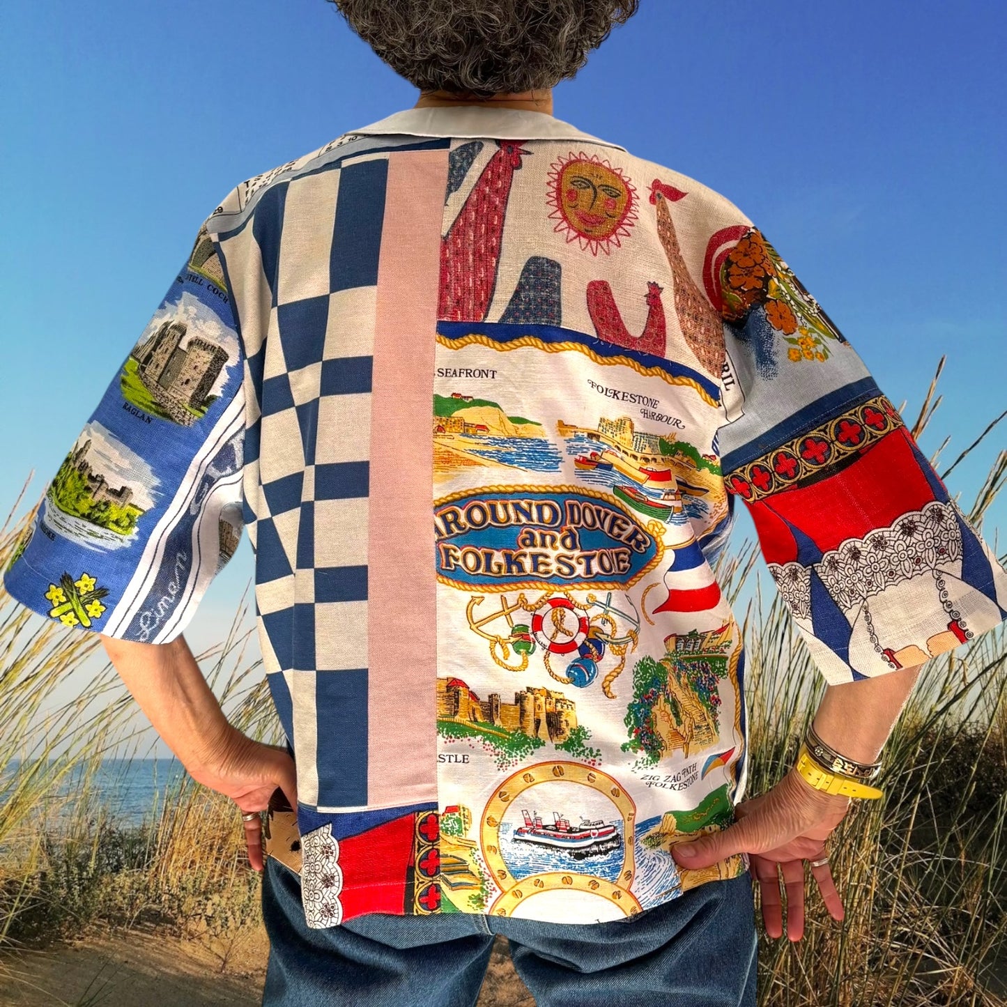 Longer length tea-shirt with pattern and travel destinations.